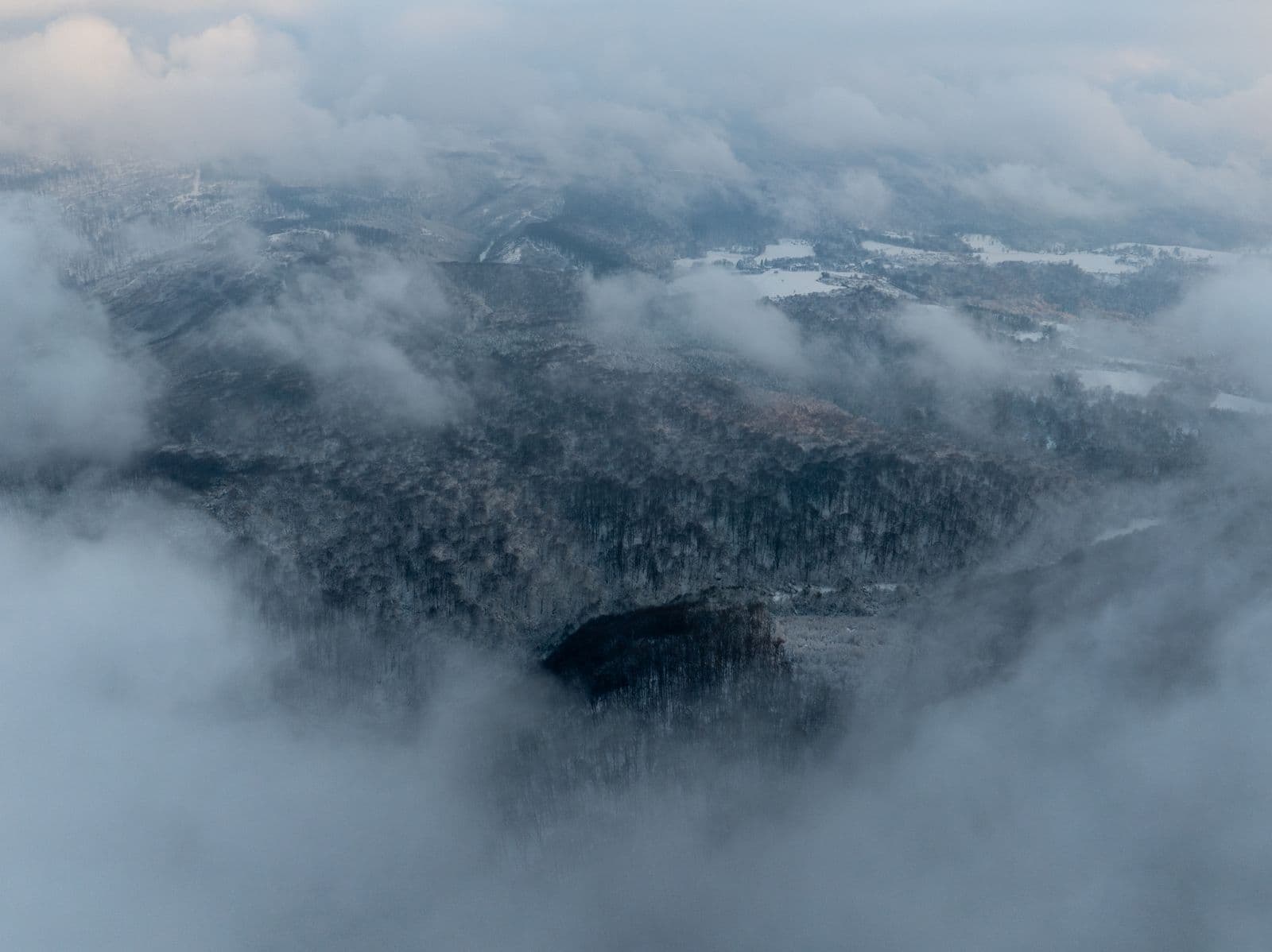 Aerial view through cloud cover — the scale we build for